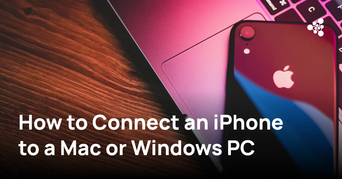 iPhone connected to a MacBook for file transfer and diagnostics